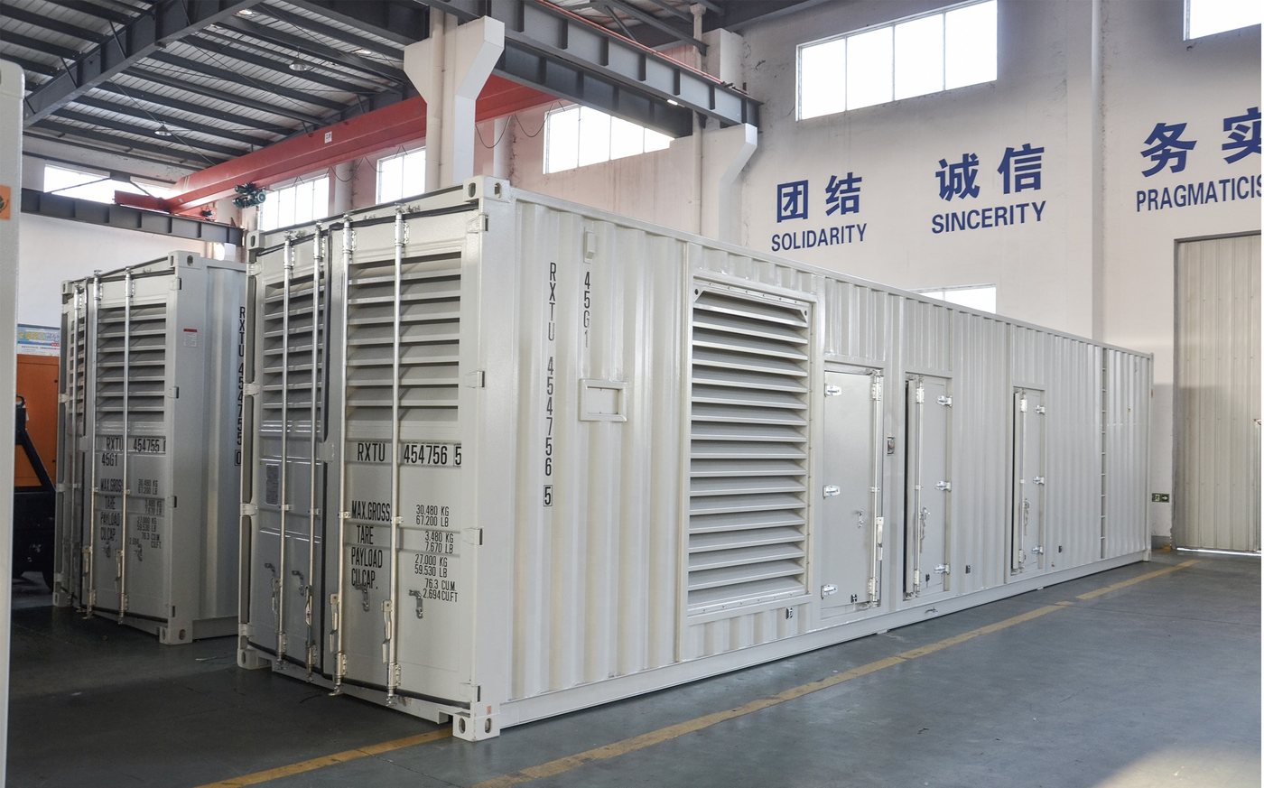Containerised Cunmi generator sets lined up in the assembly hall before dispatch to a data-centre campus